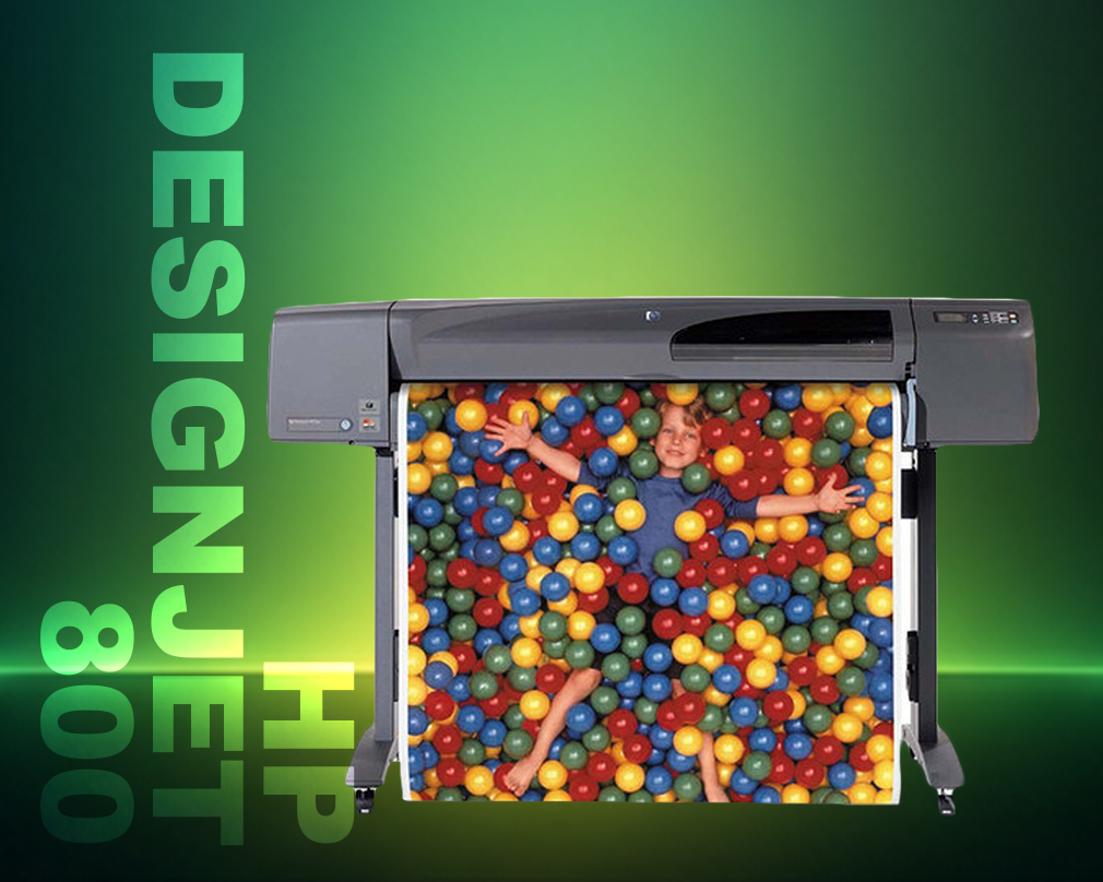 HP DesignJet 800 printer with a person playing with colorful balls inside it on a green background.